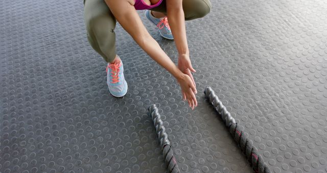 Woman Preparing for Exercise with Resistance Bands in Gym - Download Free Stock Images Pikwizard.com