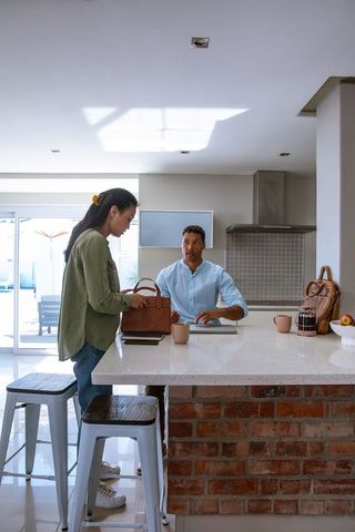 Diverse Couple Interacting at Modern Kitchen Island Critical Moment