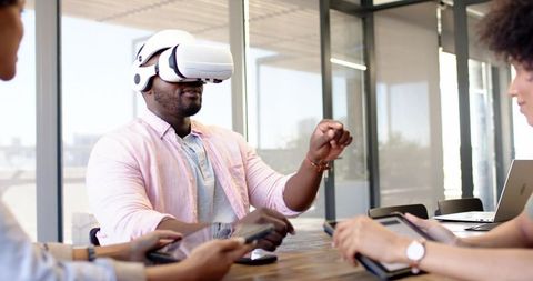Team collaborating in office with virtual reality technology