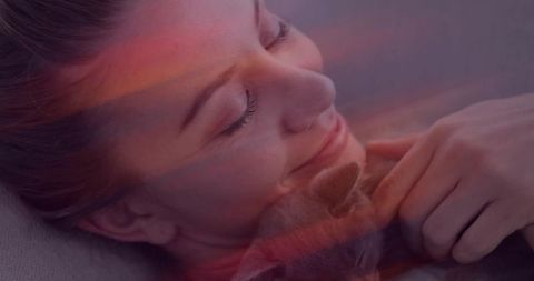 Relaxed Woman Cuddling Cat in Cozy Home Environment