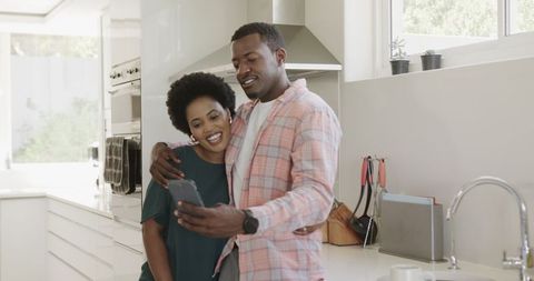 African American Couple Taking Selfie in Modern Kitchen