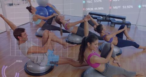 Group performing core balance exercises on bosu balls in studio for stability training