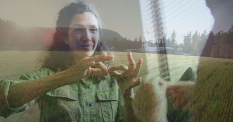 Woman signing messages with farmhouse backdrop