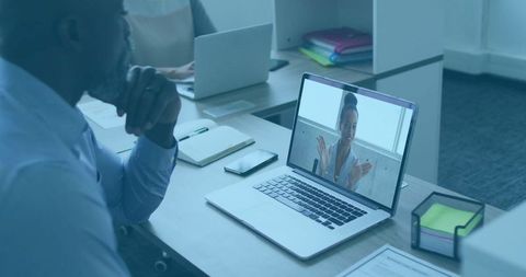 Virtual Meeting with Remote Team Member in Modern Office