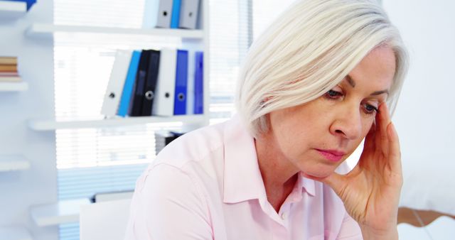 Senior Woman Looking Stressed at Work Desk in Office - Download Free Stock Images Pikwizard.com