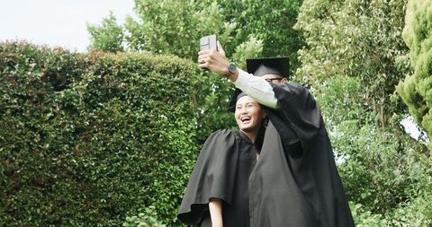 Graduating Couple Takes Joyful Selfie Celebrating Success