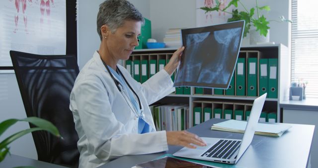 Female Doctor Analyzing X-Ray on Laptop in Medical Office - Download Free Stock Images Pikwizard.com