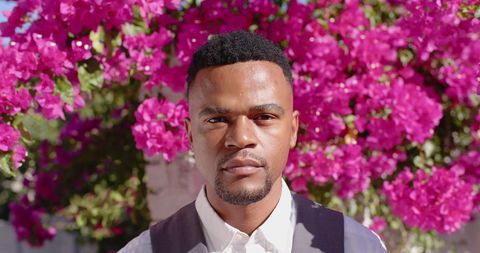 Confident man portrait with pink bougainvillea background