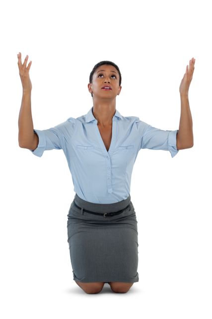 Businesswoman kneeling with hands raised, expressing worry and seeking help. Ideal for concepts related to stress, faith, hope, and corporate challenges. Useful for articles, presentations, and advertisements focusing on workplace stress, emotional support, and professional struggles.