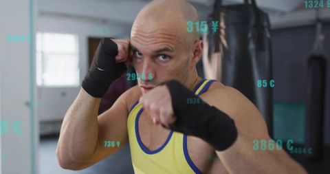 Boxer punching toward camera in gym wearing yellow tank and hand wraps with hud