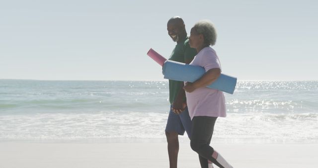 Senior Couple Walking on Beach with Yoga Mats Enjoying Exercise - Download Free Stock Images Pikwizard.com