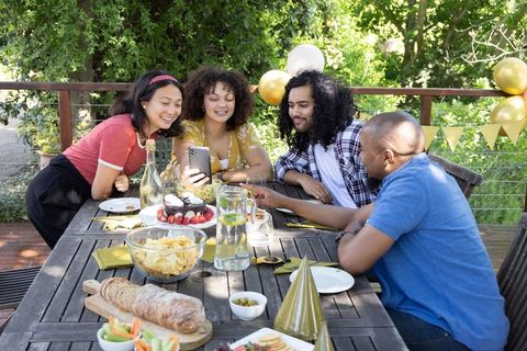 Diverse Friends Enjoy Leisurely Outdoor Celebration at Patio Table