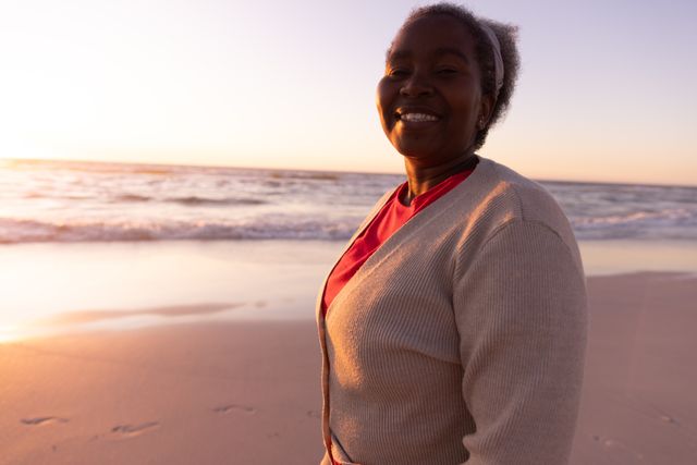 Smiling Senior African American Woman Enjoying Beach at Sunset - Download Free Stock Images Pikwizard.com