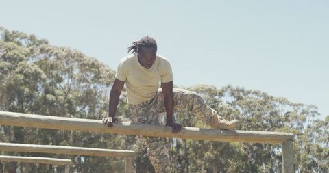 Soldier overcoming obstacle on military training course