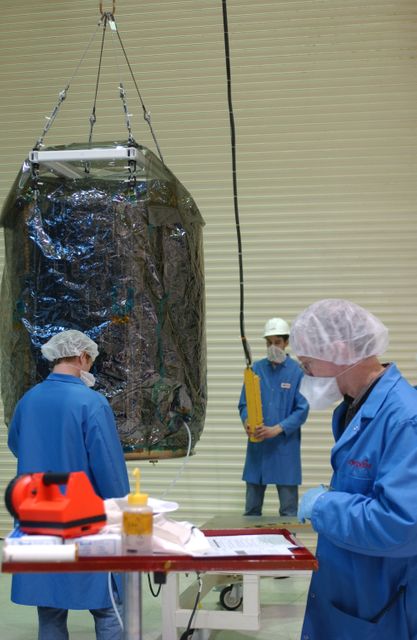 In Building 1555 at North Vandenberg Air Force Base, workers lift the AIM spacecraft from its stand in order to move it into an area where a partial deployment of the solar arrays on the spacecraft will take place. The AIM spacecraft will fly three instruments designed to study polar mesospheric clouds located at the edge of space, 50 miles above the Earth's surface in the coldest part of the planet's atmosphere. The mission's primary goal is to explain why these clouds form and what has caused them to become brighter and more numerous and appear at lower latitudes in recent years. AIM's results will provide the basis for the study of long-term variability in the mesospheric climate and its relationship to global climate change. AIM is scheduled to be mated to the Pegasus XL during the second week of April, after which final inspections will be conducted. Launch is scheduled for April 25.