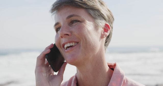 Smiling Woman Talking on Phone at Beach - Download Free Stock Images Pikwizard.com