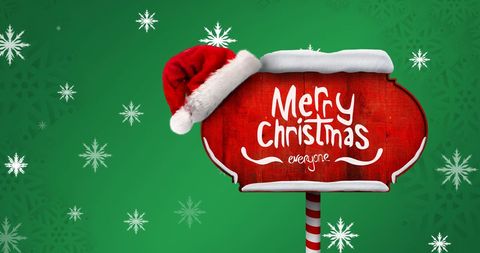 Festive Christmas Sign with Santa Hat in Winter Wonderland