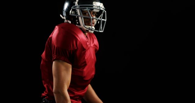 American Football Player in Red Jersey on Dark Background - Download Free Stock Images Pikwizard.com