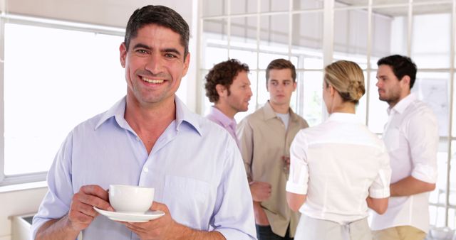 Smiling Man Holding Coffee Cup During Office Break - Download Free Stock Images Pikwizard.com