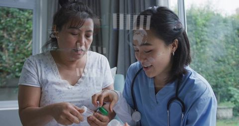 Nurse guiding patient with medication bottle during home health consultation