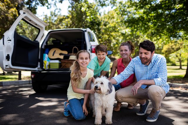 Family enjoying time together in a park with their dog. Ideal for use in advertisements, family-oriented content, travel promotions, pet care services, and lifestyle blogs.
