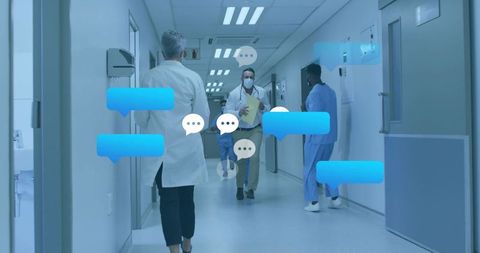 Medical team walking in hospital corridor communicating with digital chat bubbles overlay