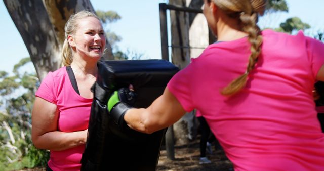 Women Practicing Self-Defense Exercises Outdoors in Pink Shirts - Download Free Stock Images Pikwizard.com