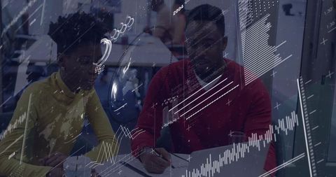 Team collaborating over analytics reports with charts and annotations in modern office