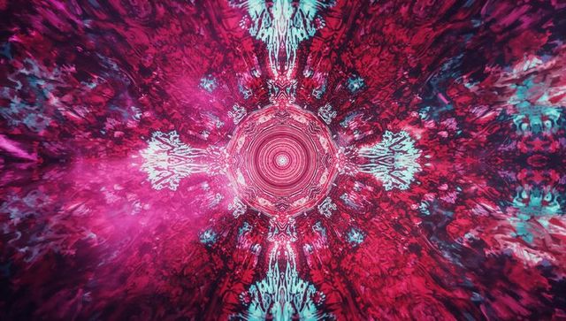 Vibrant symmetrical mandala with pink and teal hues