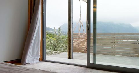 Serene Deck with Rattan Swing and Misty Mountain View