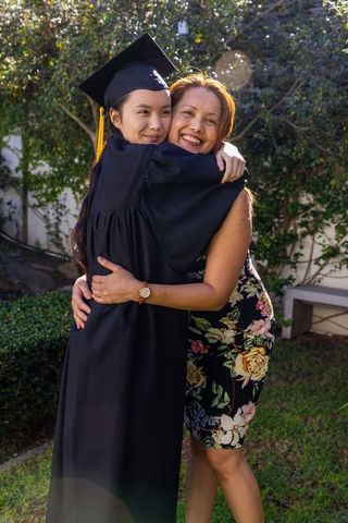 Mother and Daughter Celebrating Graduation Together Outdoors