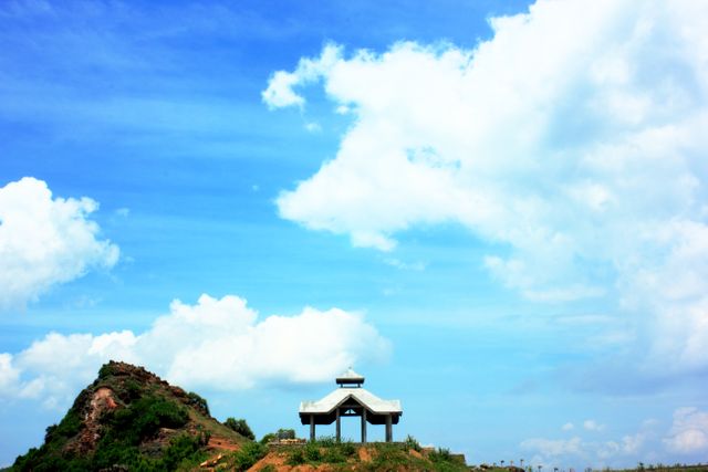 Scenic Pavilion on Hilltop Under Blue Sky and White Clouds - Download Free Stock Photos Pikwizard.com