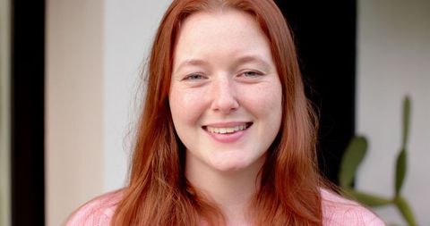 Smiling Woman by Door with Green Succulent