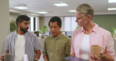 Diverse Team Collaborating with Coffee in Modern Office