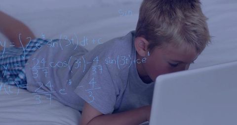 Boy using laptop on bed with math equations overlay for online learning and home study