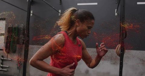 Determined athlete training intensely in modern gym