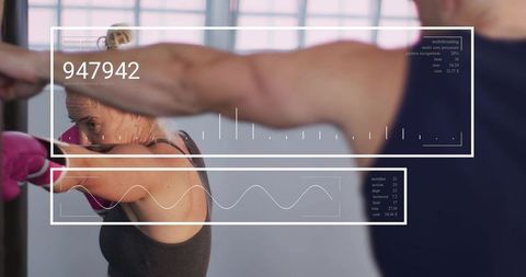 Female Athlete Punching Mitt During Boxing Training with Digital HUD Performance Overlay