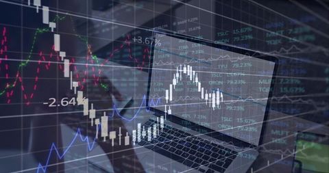 Laptop Displaying Candlestick Charts and Market Analytics Overlays on Office Desk