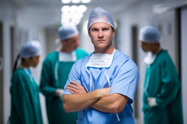 Confident Male Nurse Standing in Hospital Corridor - Download Free Stock Photos Pikwizard.com