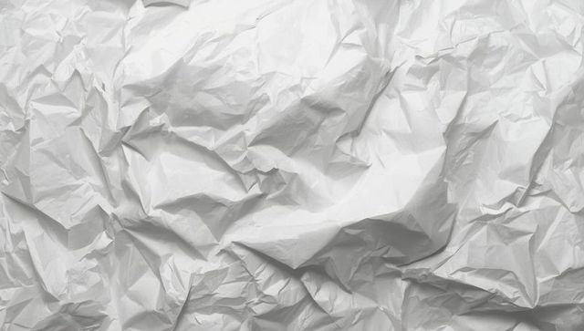 Crumpled white paper sheet texture with irregular folds