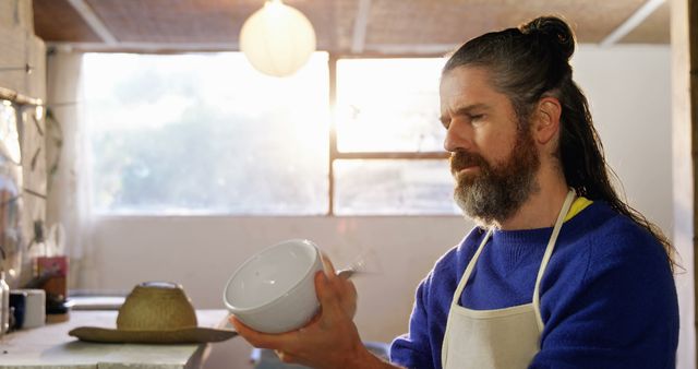 Middle-aged Man in Apron Inspecting Ceramic Bowl in Crafts Workshop - Download Free Stock Images Pikwizard.com