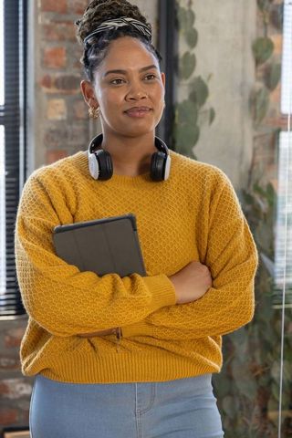 Stylish African American Woman Posing in Creative Loft Office