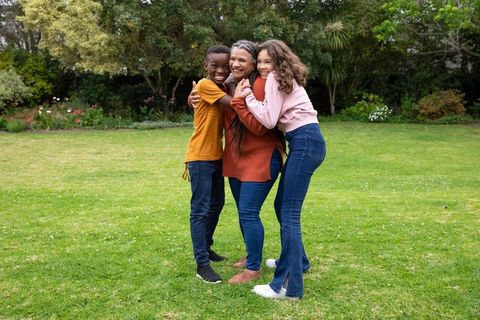 Diverse Family Embracing in Green Lush Garden Setting