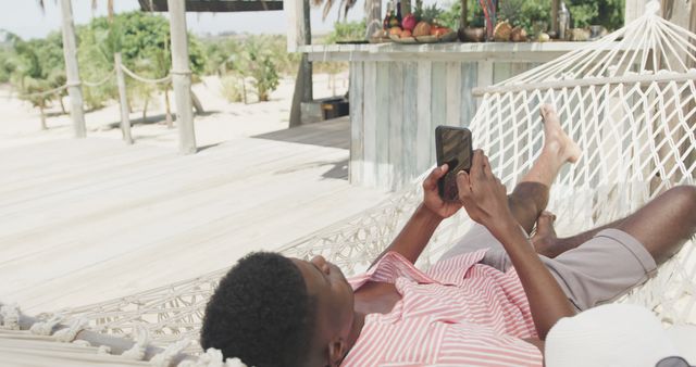 Relaxing on Beach Hammock Using Smartphone - Download Free Stock Images Pikwizard.com