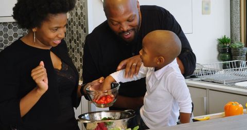Happy African American Family Cooking Together in Kitchen