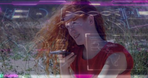Red-haired woman speaking into smartphone on dunes with holographic tech overlays