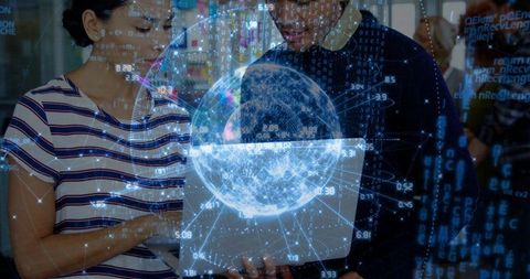 Tech team collaborating on laptop with holographic globe data visualization analytics