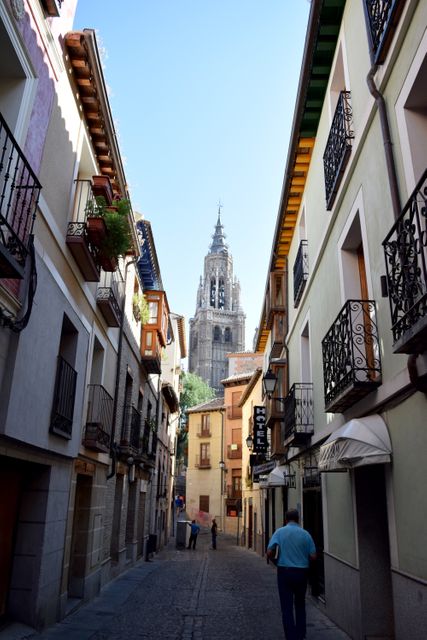 People walking down charming narrow street in historic European town - Download Free Stock Images Pikwizard.com