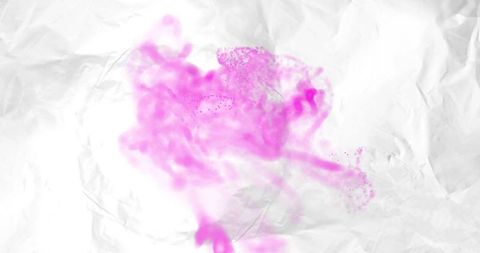 Magenta ink cloud spreading across crumpled white paper minimal abstract pigment art