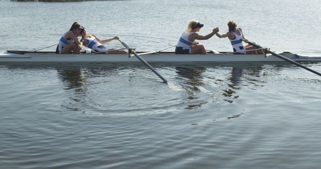 Women's rowing team celebrating during outdoor practice on lake - Download Free Stock Images Pikwizard.com